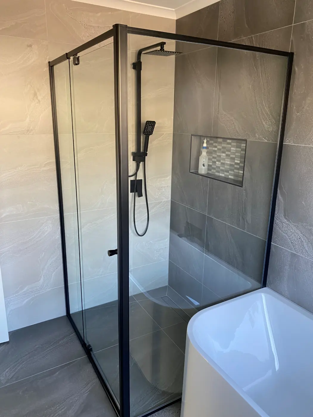 Black framed corner shower screen installed by Lynbrook Glass